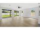 Open and bright living room with wood floors, a modern ceiling fan, and large windows overlooking the backyard at 1109 Naples Dr, Orlando, FL 32804