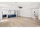 Spacious open-concept living room showcasing wood floors, a modern ceiling fan, and stylish kitchen view at 1109 Naples Dr, Orlando, FL 32804