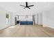 Bright living room features wood floors, recessed lighting, open to a kitchen with white cabinets and a blue island at 1109 Naples Dr, Orlando, FL 32804