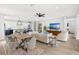 Bright open-concept living room features modern furnishings, adjacent kitchen with white cabinetry and an eat-in island at 1109 Naples Dr, Orlando, FL 32804