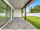 Covered outdoor patio with brick flooring, wooden beams, and backyard view at 1109 Naples Dr, Orlando, FL 32804