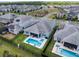 Aerial view of a home with a backyard pool and spa in a fenced yard at 11927 Charades St, Orlando, FL 32832