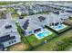 Aerial view of a home with a private pool, spa, and green backyard at 11927 Charades St, Orlando, FL 32832