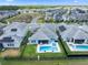 Aerial view of a home with a backyard pool and spa in a fenced yard at 11927 Charades St, Orlando, FL 32832