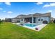 Backyard featuring a modern swimming pool, screened patio, and well-maintained lawn at 11927 Charades St, Orlando, FL 32832