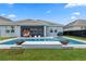 Spacious backyard with a refreshing pool, stylish patio, and comfortable seating perfect for outdoor relaxation and entertaining at 11927 Charades St, Orlando, FL 32832