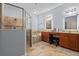 Bathroom with a glass door shower and a vanity featuring a double sink at 11927 Charades St, Orlando, FL 32832
