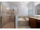 Bright bathroom featuring a glass door shower, bathtub, and vanity with a double sink at 11927 Charades St, Orlando, FL 32832