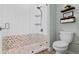 Bright bathroom featuring tiled walk-in shower with glass door, toilet, and decorative shelves at 11927 Charades St, Orlando, FL 32832