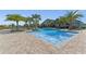 Beautiful community pool with a zero entry, ample seating and lush landscaping at 11927 Charades St, Orlando, FL 32832
