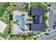 Aerial view of a community pool featuring ample seating, lush landscaping and recreational amenities at 11927 Charades St, Orlando, FL 32832