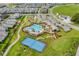 Stunning aerial view of the community pool, clubhouse, tennis court, and recreation area at 11927 Charades St, Orlando, FL 32832