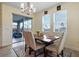 Dining area featuring a table with upholstered chairs and a sliding glass door leading to the patio at 11927 Charades St, Orlando, FL 32832