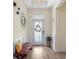 The stylish entryway boasts beautiful hardwood floors, contemporary lighting, and a cozy bench with accent pillows at 11927 Charades St, Orlando, FL 32832