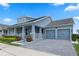 Beautifully landscaped home features a two-car garage and charming front porch, enhancing its curb appeal at 11927 Charades St, Orlando, FL 32832