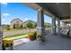 Inviting covered front porch with stone accents, perfect for relaxing and enjoying the neighborhood's ambiance at 11927 Charades St, Orlando, FL 32832