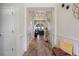 Elegant hallway with hardwood floors, decorative lighting, and wall accents leading to the bright and spacious living areas at 11927 Charades St, Orlando, FL 32832