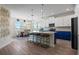 Modern kitchen with island seating and adjacent dining area at 11927 Charades St, Orlando, FL 32832