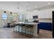 Eat-in kitchen boasts stainless appliances and an island with seating at 11927 Charades St, Orlando, FL 32832