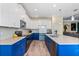 Spacious open kitchen with stainless steel appliances, large island, and modern lighting at 11927 Charades St, Orlando, FL 32832