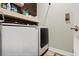 Convenient laundry room equipped with modern Samsung washer and dryer and overhead storage shelves at 11927 Charades St, Orlando, FL 32832