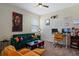 Bright office space with a desk setup, green sofa with colorful pillows, and Bob Marley art at 11927 Charades St, Orlando, FL 32832