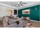 Comfortable living room with large sectional and green accent wall with TV at 11927 Charades St, Orlando, FL 32832