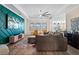 Bright living room with modern design features, a stylish accent wall, and comfortable seating for relaxation and entertainment at 11927 Charades St, Orlando, FL 32832