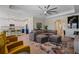 Spacious living room with large sectional, modern fan, and open floorplan at 11927 Charades St, Orlando, FL 32832