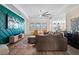 Comfortable living room featuring a decorative accent wall, modern furniture, and an open layout at 11927 Charades St, Orlando, FL 32832
