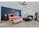 Primary bedroom featuring a tray ceiling, a ceiling fan, neutral carpet, and comfortable seating at 11927 Charades St, Orlando, FL 32832