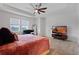 Bright, airy main bedroom with large windows and views, comfortable furniture, and modern TV at 11927 Charades St, Orlando, FL 32832