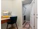 Home office nook featuring a desk and chair next to a laundry room with a modern washer and dryer at 11927 Charades St, Orlando, FL 32832
