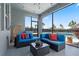 Relaxing screened-in patio featuring comfortable seating, stylish decor, and views of the backyard and pool area at 11927 Charades St, Orlando, FL 32832