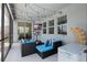 Inviting screened patio with comfortable seating, ceiling fan, and string lights for relaxing evenings at 11927 Charades St, Orlando, FL 32832