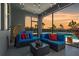 Cozy screened patio with stylish furniture, string lights, and views of the pool and scenic sunset at 11927 Charades St, Orlando, FL 32832