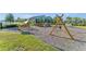 Community playground with multiple play structures, swings, and a soft landing surface at 11927 Charades St, Orlando, FL 32832