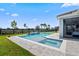 Stunning backyard pool with a built-in spa, waterfall feature, and spacious patio area for outdoor enjoyment at 11927 Charades St, Orlando, FL 32832