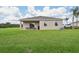The backyard boasts a covered patio and ample green space, perfect for outdoor activities and relaxation at 1240 Blue Daze Ln, Eustis, FL 32726