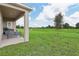 View of the covered patio and expansive backyard, great for outdoor activities and entertaining at 1240 Blue Daze Ln, Eustis, FL 32726