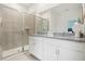 Bathroom with a double sink vanity, granite countertops, tiled shower and floors, and modern fixtures at 1240 Blue Daze Ln, Eustis, FL 32726