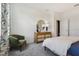 Comfortable bedroom featuring a bed, modern dresser with a mirror, and green accent chair at 1240 Blue Daze Ln, Eustis, FL 32726