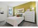 Well-lit bedroom showcases a large window, a comfortable bed, and stylish decor accents at 1240 Blue Daze Ln, Eustis, FL 32726