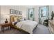 Stylishly decorated bedroom featuring a queen-sized bed, side table, and three decorative artworks at 1240 Blue Daze Ln, Eustis, FL 32726