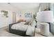 Cozy bedroom with a padded headboard, neutral decor, carpeted floor, and natural light from a window at 1240 Blue Daze Ln, Eustis, FL 32726