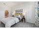 Cozy bedroom featuring a bed with neutral bedding, wood bedside table, and stylish decor at 1240 Blue Daze Ln, Eustis, FL 32726