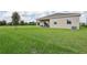 Exterior showing a covered patio and large yard, offering a serene outdoor experience at 1240 Blue Daze Ln, Eustis, FL 32726