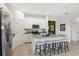 Beautiful kitchen featuring a large island with seating, white cabinets, stainless steel appliances and tile flooring at 1240 Blue Daze Ln, Eustis, FL 32726