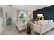 Cozy living room with neutral decor, plush seating, and access to the backyard at 1240 Blue Daze Ln, Eustis, FL 32726