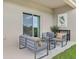 Cozy covered patio with modern outdoor seating, perfect for relaxing and enjoying the backyard at 1240 Blue Daze Ln, Eustis, FL 32726
